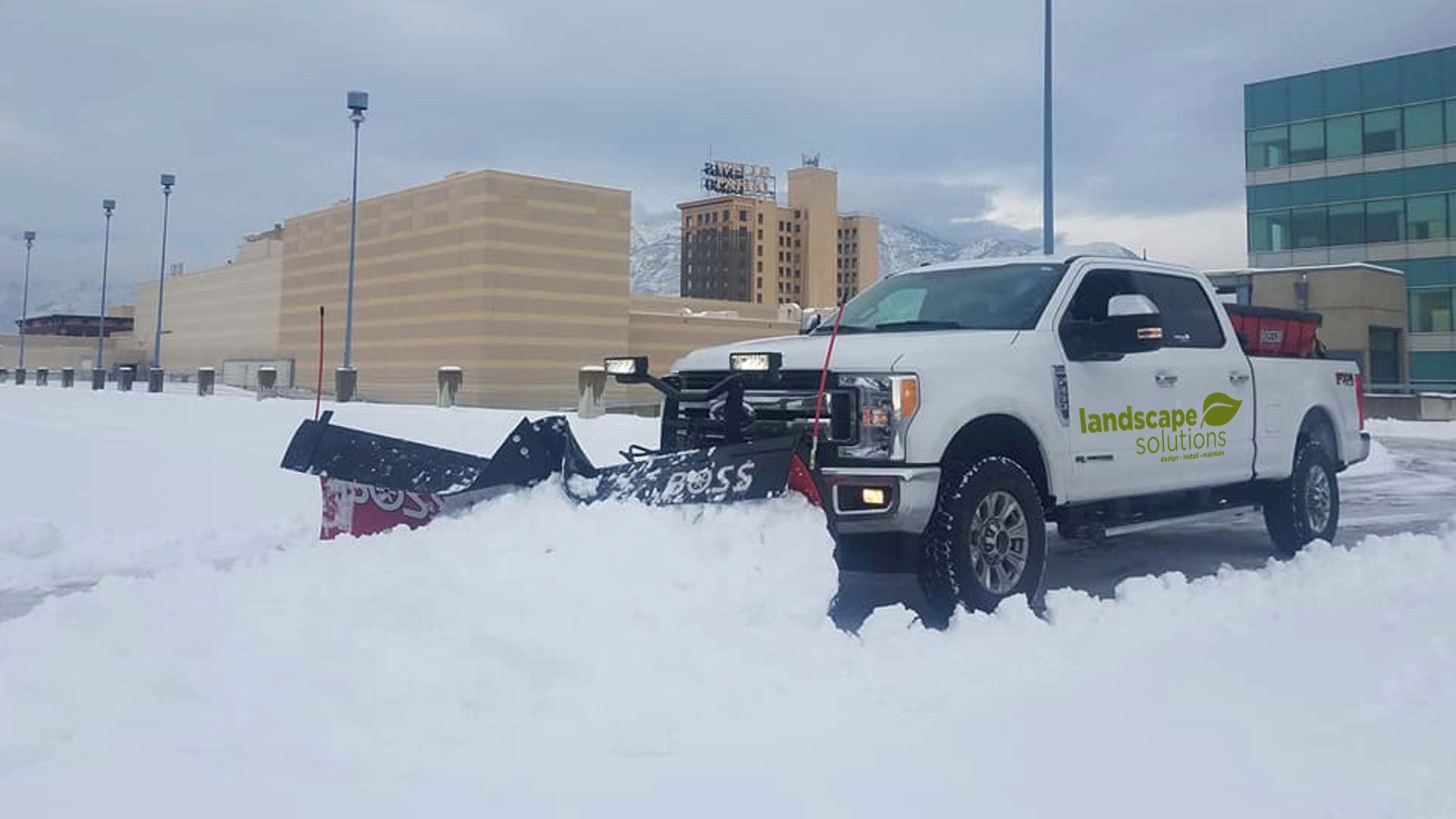 Our truck and plow removing snow from a large commercial parking lot located in Ogden, UT.